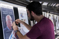 <p>Will Simms, Newseum graphics specialist, posts the Arizona Republic’s front page at the Newseum’s front page display on Sunday, Aug. 26, 2018, the morning after Sen. John McCain’s passing. (Photo: Bill Clark/CQ Roll Call/Getty Images) </p>