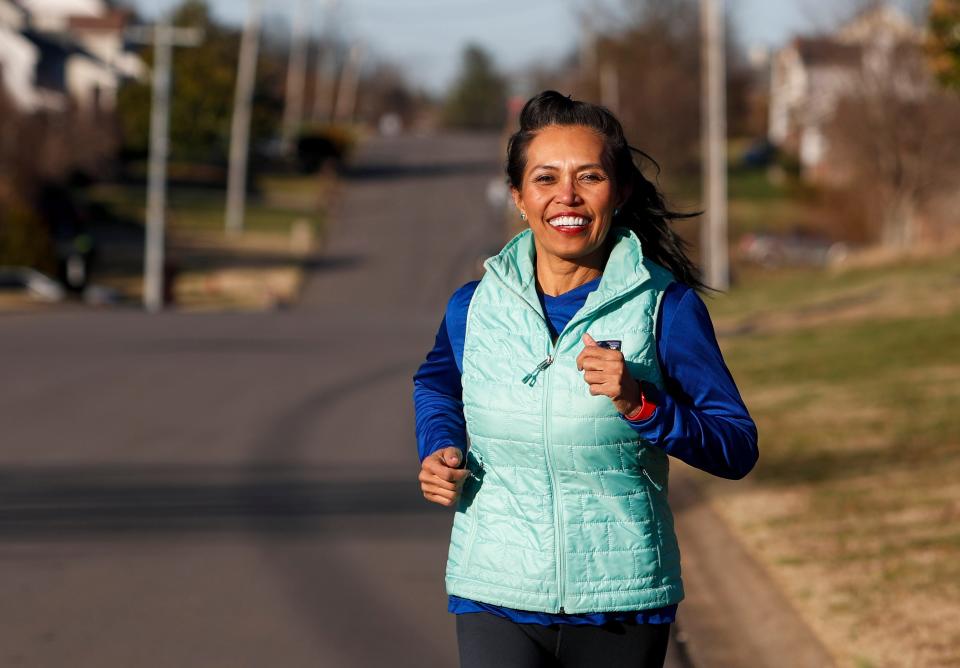 Maria Shircel runs down the block in the neighborhood outside Maria Shircel Realty in Clarksville, Tenn., on Wednesday, Jan. 12, 2022. 