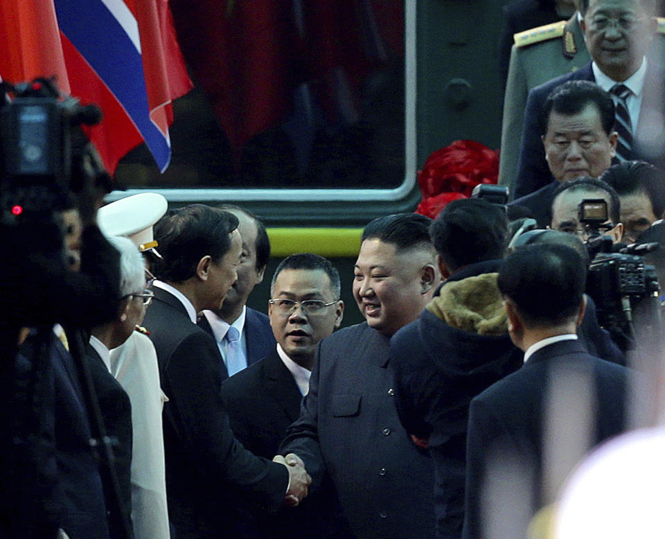 North Korean leader Kim Jong Un, center right, is welcomed upon arrival by train in Dong Dang in Vietnamese border town Tuesday, Feb. 26, 2019, ahead of his second summit with U.S. President Donald Trump. (AP Photo/Minh Hoang)