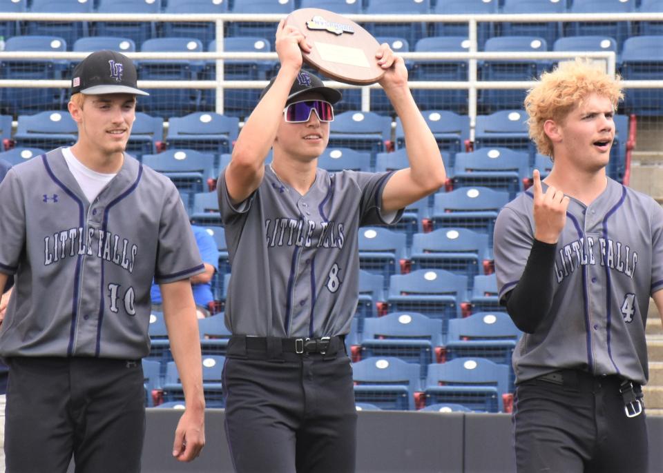 Little Falls Mountie seniors Brayton Langdon, Jack Morotti and Chase Regan (from left) show off the regional championship plaque the team earned by beating the Schuyler Storm Saturday in a Class C regional baseball playoff game.