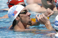 Michael Phelps stops for a drink during training Wednesday, April 23, 2014, in Mesa, Ariz. Phelps is competing in the Arena Grand Prix in Mesa on Thursday in an attempt to return to swimming. (AP Photo/Matt York)