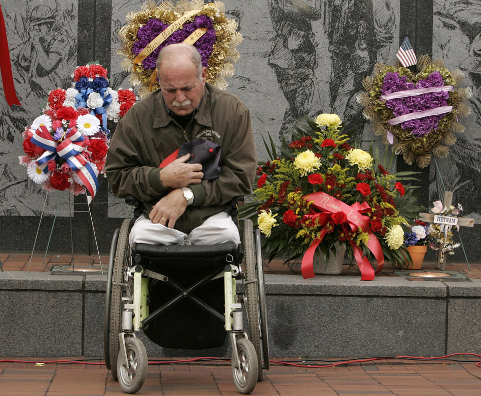 <p>Dennis Best, vice president of the Philadelphia Vietnam Veterans Memorial Fund, places his cap over his heart during the recitation of a benediction at a Veterans Day ceremony at the Vietnam memorial site in Philadelphia, Nov. 11, 2005. (Photo: Jacqueline Larma/AP) </p>