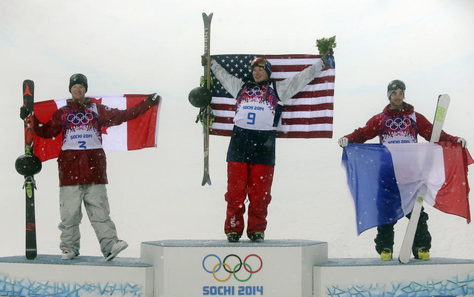 Gold medalist David Wise of the United States, center, celebrates with silver medalist Mike Riddle of Canada, left, and bronze medalist Kevin Rolland of France, after the men's ski halfpipe final at the Rosa Khutor Extreme Park, at the 2014 Winter Olympics, Tuesday, Feb. 18, 2014, in Krasnaya Polyana, Russia. (AP Photo/Sergei Grits)