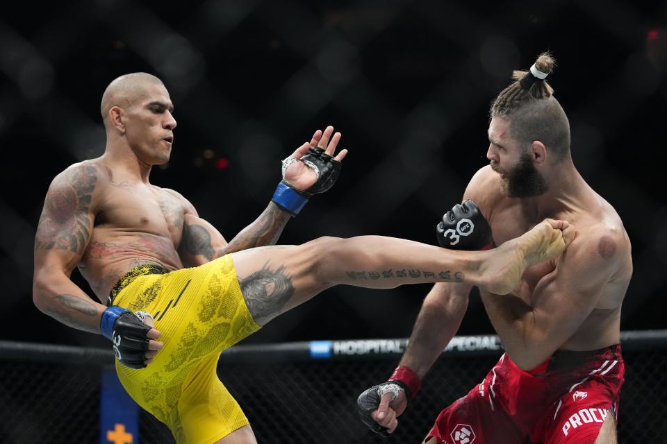 Brazil's Alex Pereira, left, kicks Czech Republic's Jirí Procházka during the second round of a light heavyweight title bout at the UFC 295 mixed martial arts event, early Sunday, Nov. 12, 2023, in New York. (AP Photo/Frank Franklin II)