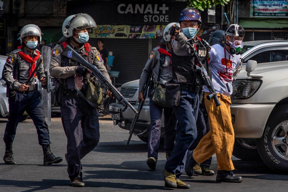 Riot police arrest protesters Feb 27 in Yangon, Myanmar. The military government has intensified a crackdown on demonstrations.