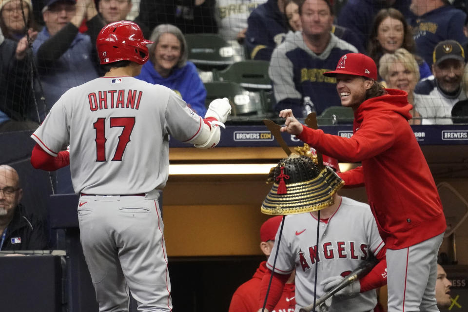 Los Angeles Angels' Shohei Ohtani (17) is congratulated in the dugout by Brett Phillips after hitting a solo home run during the third inning of a baseball game against the Milwaukee Brewers, Sunday, April 30, 2023, in Milwaukee. (AP Photo/Aaron Gash)