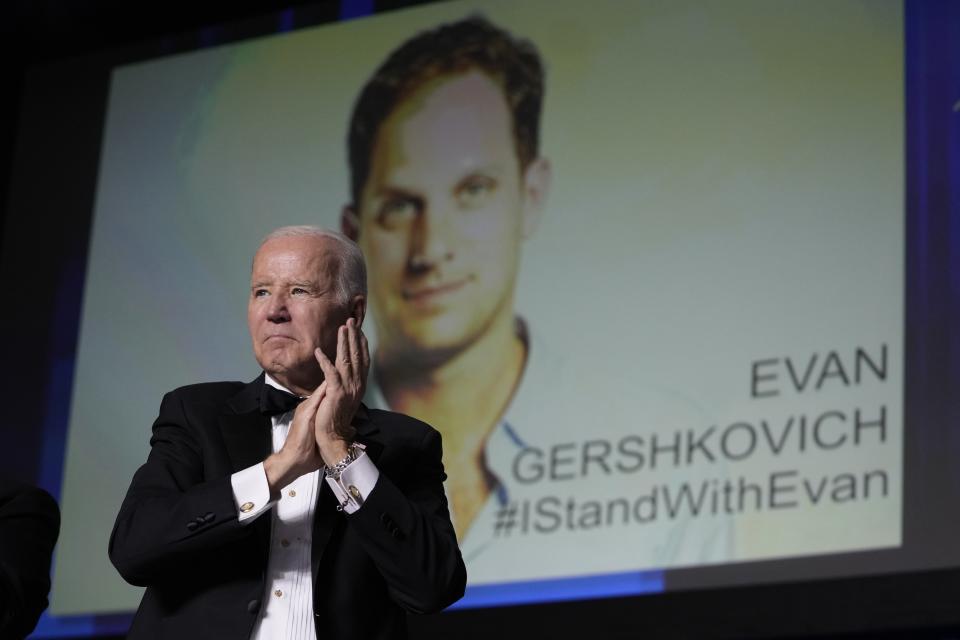 FILE – U.S. President Joe Biden appears in front of an image of jailed journalist Evan Gershkovich during the White House Correspondents' Association dinner at the Washington Hilton in Washington, on Saturday, April 29, 2023. Gershkovich is accused of espionage – charges that he, his employer and the U.S. government deny. Biden's administration has promised to bring him home, but the Russian Foreign Ministry has said it would consider a swap only after a verdict in his trial. (AP Photo/Carolyn Kaster, File)