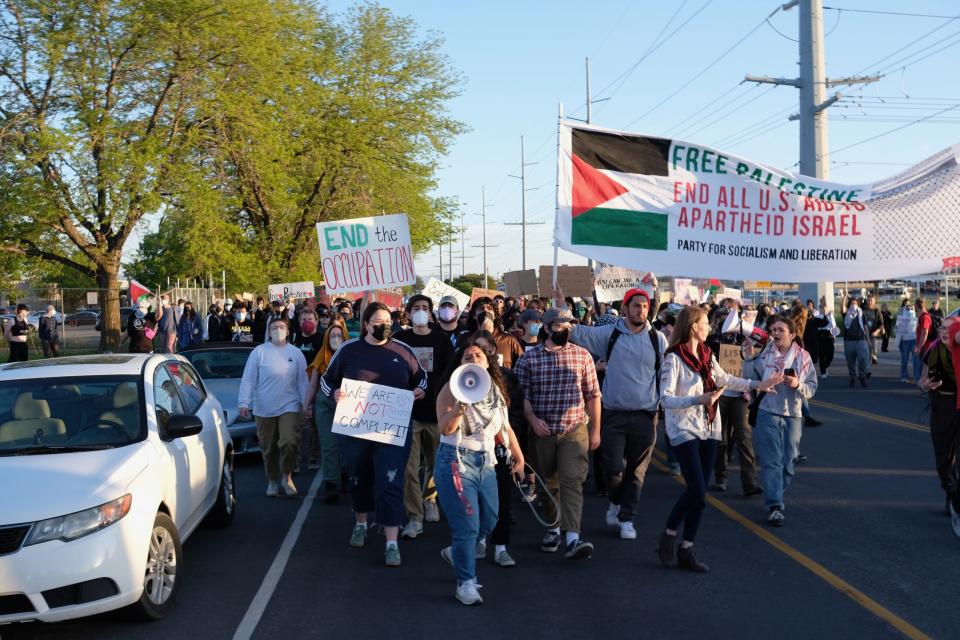 Pro-Palestine protesters march in the street outside of the Salt Lake County Jail in South Salt Lake after a student organizer was arrested on Tuesday, April 30, 2024.