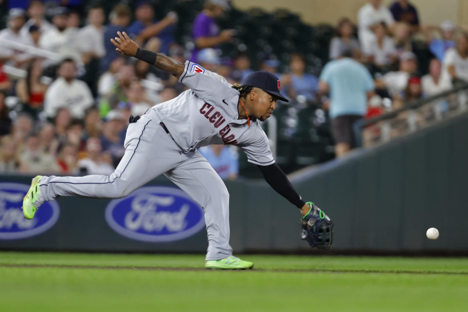 Cleveland Guardians third baseman Jose Ramirez cannot reach a hit by Minnesota Twins' Donovan Solano in the fifth inning of a baseball game Monday, Aug. 28, 2023, in Minneapolis. (AP Photo/Bruce Kluckhohn)