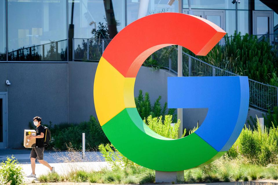 In this file photo taken on June 27, 2022, a worker walks along a path at Google's Bay View campus in Mountain View, California. Google's parent company Alphabet announced about 12,000 job cuts globally on January 20, 2023, citing a changing "economic reality", becoming the latest US tech giant to enact large-scale restructuring.