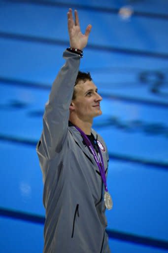 Silver medalist US swimmer Ryan Lochte waves during a lap of honour after the podium ceremony for the men's 200m individual medley swimming event at the London 2012 Olympic Games in London