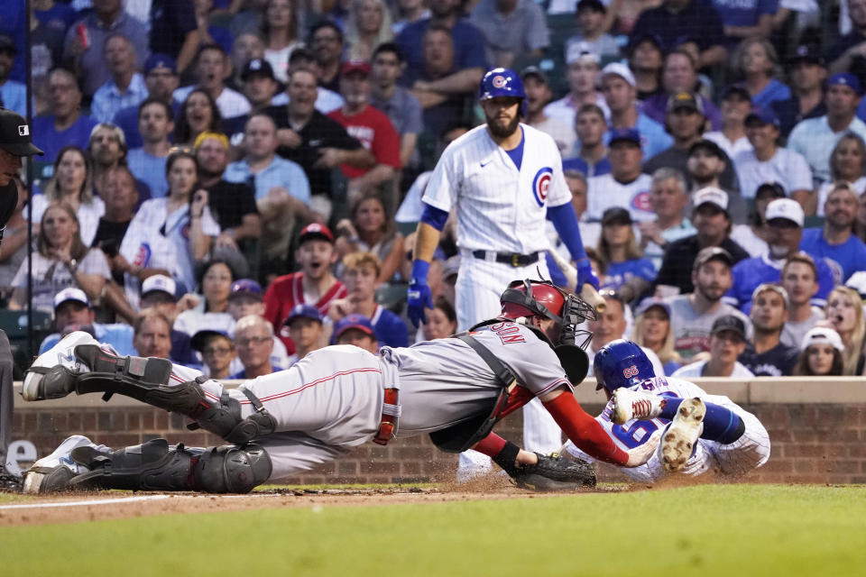 Cincinnati Reds catcher Tyler Stephenson, left, tags out Chicago Cubs' Rafael Ortega at home during the third inning of a baseball game Tuesday, July 27, 2021, in Chicago. (AP Photo/David Banks)