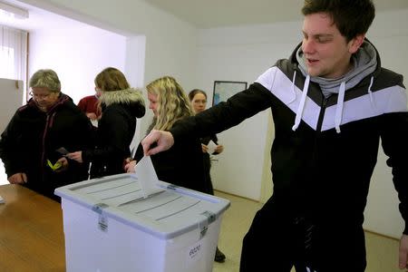 A man casts a ballot at the polling station during referendum on whether to give same-sex couples the right to marry and to adopt children, in Naklo, Slovenia December 20, 2015. REUTERS/Srdjan Zivulovic