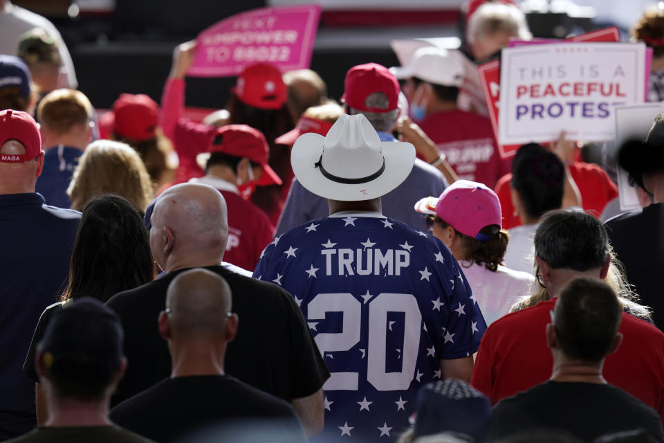 People wait for President Donald Trump to arrive at a campaign rally at Manchester-Boston Regional Airport, Friday Aug. 28, 2020 in Londonderry, N.H. (AP Photo/Charles Krupa)