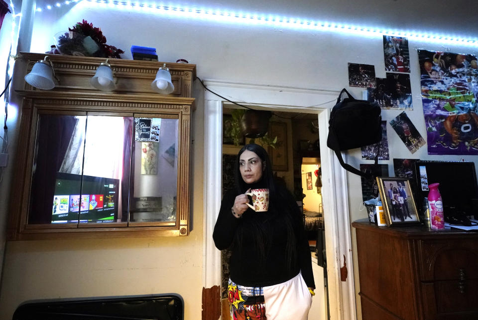 Isabel Miranda drinks coffee, Wednesday, March 10, 2021, in her rental apartment where she lives with her partner and two sons, in Haverhill, Mass. The Biden administration is extending a federal moratorium on evictions of tenants who've fallen behind on rent during the coronavirus pandemic. Miranda, who has an eviction hearing next month from her apartment, said she had mixed feelings about the extension. She worries that the courts and the landlord will not recognize the federal moratorium but also recognizes it gives her time to come up with the nearly $10,000 in back rent. (AP Photo/Elise Amendola)