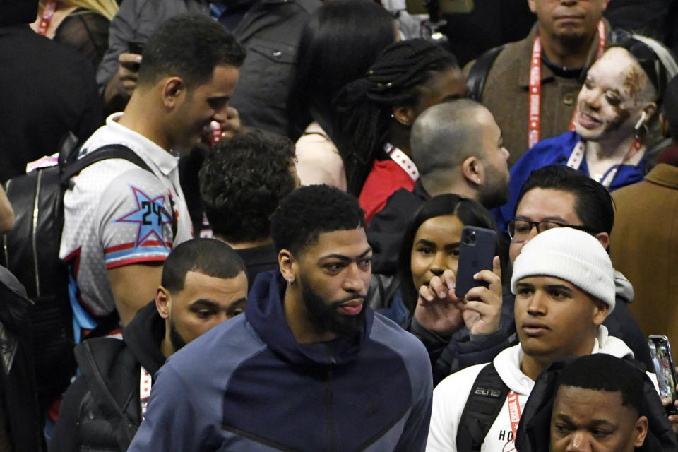 Anthony Davis, foreground, of the Los Angeles Lakers walks through the media during the NBA All-Star basketball game media day, Saturday, Feb. 15, 2020, in Chicago. (AP Photo/David Banks)