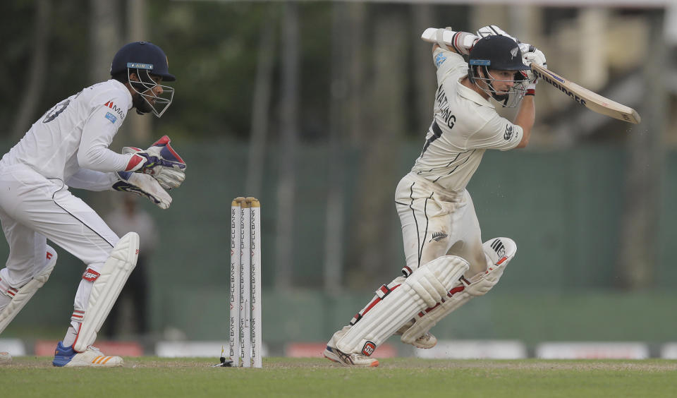 New Zealand's BJ Watling plays a shot as Sri Lanka's Lahiru Thirimanne watches during day four of the second test cricket match between Sri Lanka and New Zealand in Colombo, Sri Lanka, Sunday, Aug. 25, 2019. (AP Photo/Eranga Jayawardena)