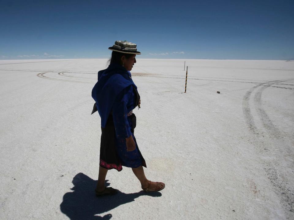 A Quechua woman walks along a dessert of salt in the Salar de Uyuni, in southern Bolivia, Thursday October 29, 2009.