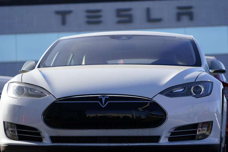 An unsold 2021 S70 sedan sits at a Tesla dealership Sunday, Nov. 8, 2020, in Littleton, Colo. Tesla will be added to the S&P 500 index on Dec. 21. Based on its market value Monday, Nov. 16, 2020, the electric car maker would be one of the top 10 companies in the benchmark index upon entry. (AP Photo/David Zalubowski)