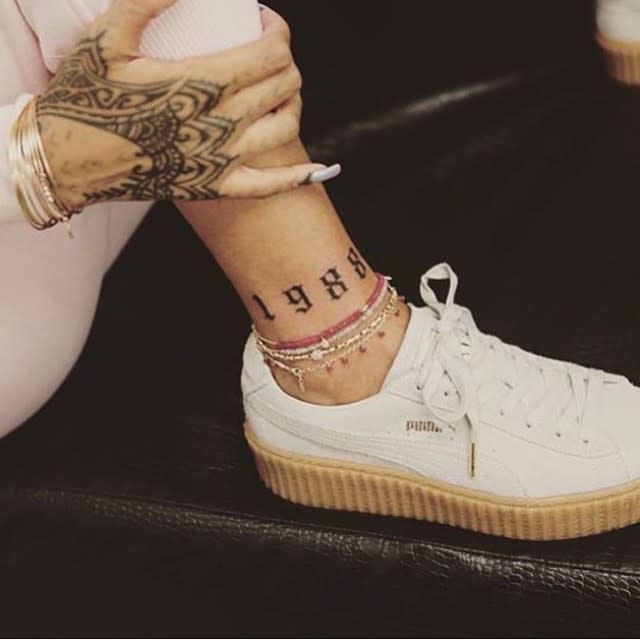 Nice ink, <strong>Rihanna</strong>! The "Bitch Better Have My Money" singer has a brand new tattoo on her ankle, and it represents her birth year! The tattoo reads, "1988," as can be seen in the 27-year-old's Instagram photo, which she captioned, "Tagged by my dear friend @bangbangnyc." <strong>PHOTOS: OMG! 11 Worst Celeb Word Tattoos </strong> The ink was done by New York City tattoo artist, Bang Bang, who has done many of Rihanna's more than 20 tattoos. WATCH: Seeing Double? Celebrities Who Have the Same Tattoos RiRi will be taking her brand new body art to <em>The Voice</em> this season, as she was just announced announced as a "key adviser" to all coaches, including <strong>Gwen Stefani, Pharrell Williams, Adam Levine</strong> and <strong>Blake Shelton</strong>. Hopefully the gig allows her enough time to put out her next album, which the singer promised ET late last year would be out "very soon." "That's my hope," she said. "I'm really excited about the music that we've been working on, so I can't wait for people to hear it." What do you think of Rihanna's new tattoo? <strong>WATCH: Nearly Naked Rihanna Takes Over Kadooment Day Parade With Best Costume Yet </strong> Watch below.