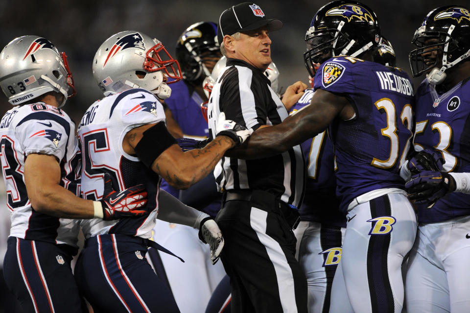 BALTIMORE, MD - SEPTEMBER 23: A referee seperates players from the New England Patriots and the Baltimore Ravens in the first half at M&T Bank Stadium on September 23, 2012 in Baltimore, Maryland. (Photo by Patrick Smith/Getty Images)