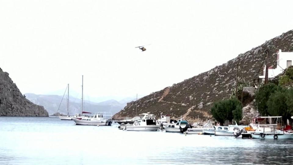 The Greek island of Symi is known for its rugged terrain and rocky cliffs (Reuters)