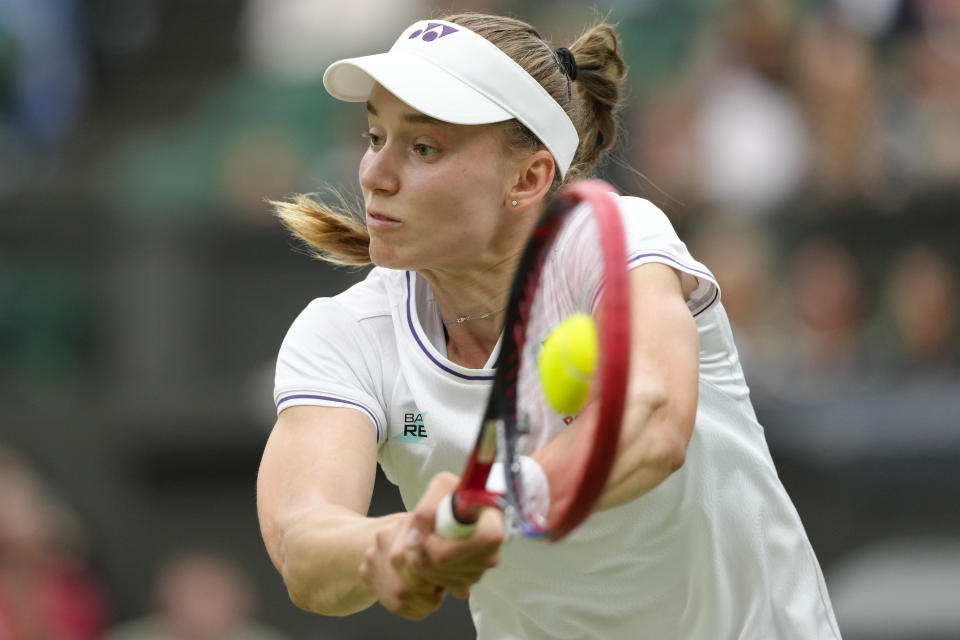 Elena Rybakina of Kazakhstan plays a backhand return to Russia's Anna Kalinskaya during their fourth round match at the Wimbledon tennis championships in London, Monday, July 8, 2024. (AP Photo/Kirsty Wigglesworth)