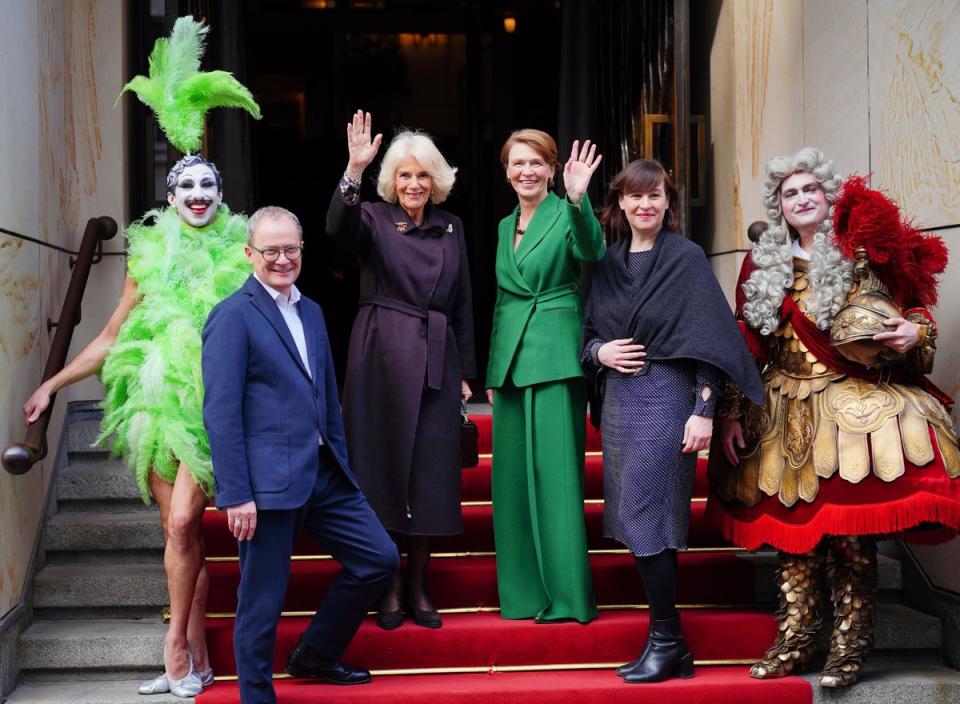 The Queen Consort and First Lady Elke Budenbender wave outside the Komische Opera Berlin (PA)