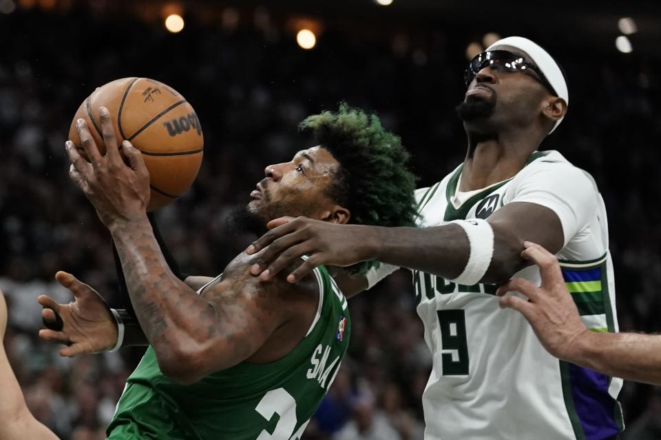 Milwaukee Bucks' Bobby Portis fouls Boston Celtics' Marcus Smart during the second half of Game 3 of an NBA basketball Eastern Conference semifinals playoff series Saturday, May 7, 2022, in Milwaukee. The Bucks won 103-101 to take a 2-0 lead in the series. (AP Photo/Morry Gash)