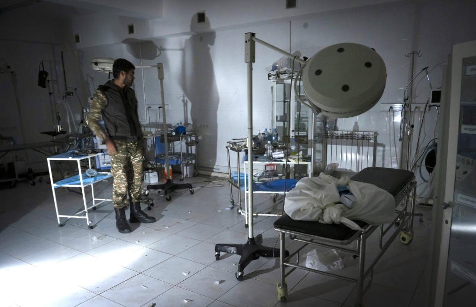 The doctor of a local hospital, damaged by shelling from Azerbaijan's artillery, stands in the surgery room of his hospital in the town of Martakert, during a military conflict, the separatist region of Nagorno-Karabakh, Thursday, Oct. 15, 2020. The conflict between Armenia and Azerbaijan is escalating, with both sides exchanging accusations and claims of attacks over the separatist territory of Nagorno-Karabakh.(AP Photo)