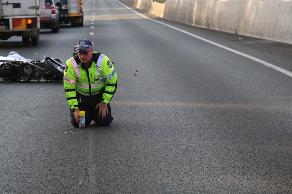 Picture of Sergeant Carl Cutler at a crash site. Sergeant Cutler is a Senior Investigator for Queensland Police's Forensic Crash Unit.