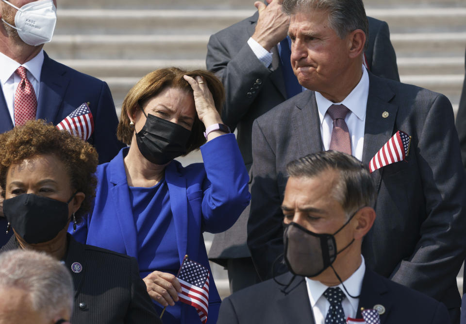 Sen. Amy Klobuchar, D-Minn., left, and Sen. Joe Manchin, D-W.Va., stand on the steps of the Capitol during a Sept. 11 remembrance ceremony, in Washington, Monday, Sept. 13, 2021. As congressional Democrats speed ahead this week in pursuit of President Joe Biden's $3.5 trillion plan for social and environmental spending, Manchin, a Democratic senator vital to the bill's fate, says the cost will need to be slashed to $1 trillion to $1.5 trillion to win his support. (AP Photo/J. Scott Applewhite)