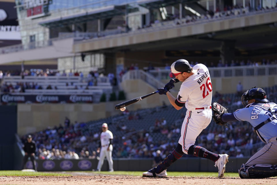 Minnesota Twins' Max Kepler hits a two-run triple during the fifth inning of a baseball game against the Tampa Bay Rays, Wednesday, Sept. 13, 2023, in Minneapolis. (AP Photo/Abbie Parr)