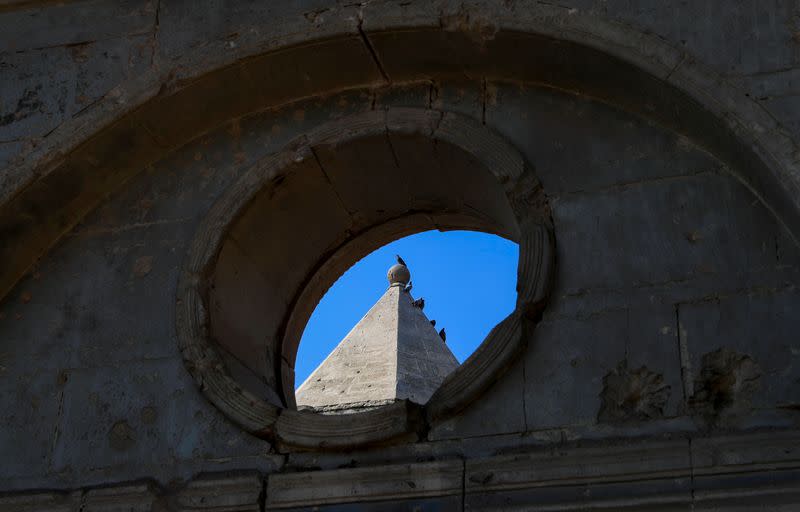 Birds rest atop of a church in the old city of Mosul