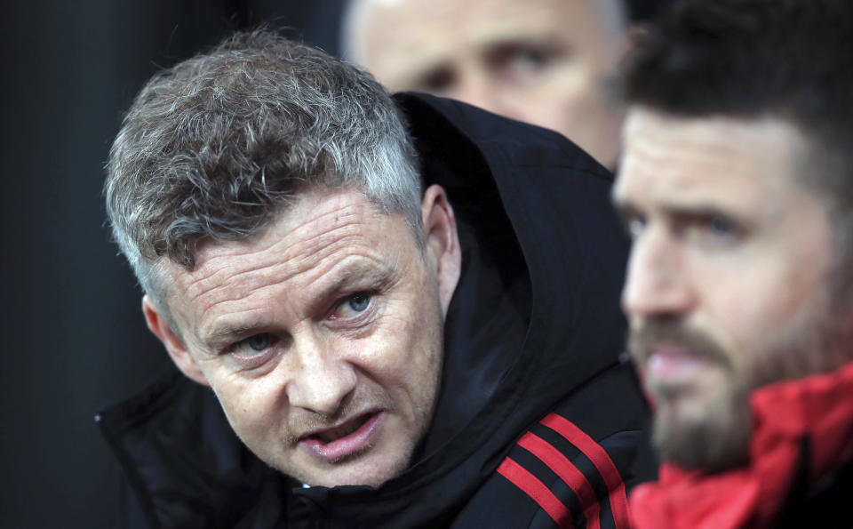 Manchester United interim manager Ole Gunnar Solskjaer, left, speaks with coach Michael Carrick during a Premier League soccer match against Newcastle United at St James' Park, Wednesday, Jan. 2, 2019, in Newcastle, England. (Owen Humphreys/PA via AP)