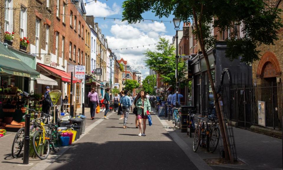 London, England, UK - June 3, 2019: Pedestrians browse shops and restuarants on Exmouth Market in London.TRRGXR London, England, UK - June 3, 2019: Pedestrians browse shops and restuarants on Exmouth Market in London.