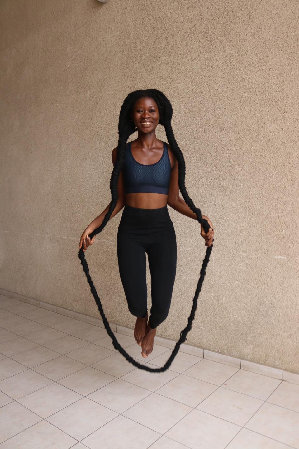 

Laetitia Ky is the record holder for the most skips over own hair in 30 seconds (Image: GUINNESS WORLD RECORDS 2022)

