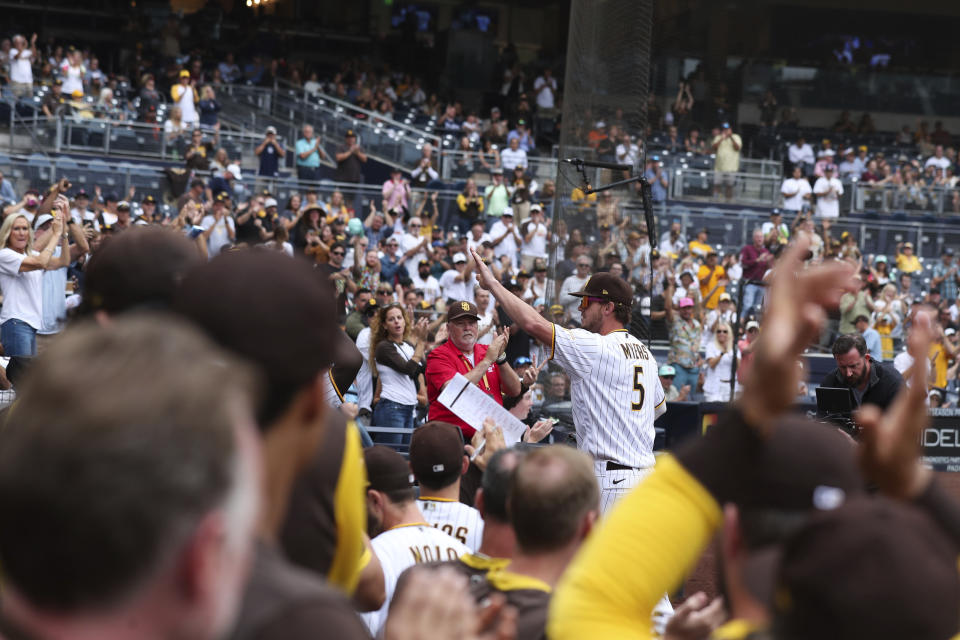 San Diego Padres' Wil Myers (5) waves to the crowd after being removed during the eighth inning of the team's baseball game against the San Francisco Giants on Wednesday, Oct. 5, 2022, in San Diego. (AP Photo/Derrick Tuskan)