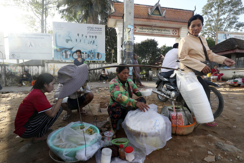 A local vendor sells traditional noodles on a sidewalk in front of the Sihanoukville Referral Hospital in Sihanoukville province, southwestern Phnom Penh, Cambodia, Friday, Nov. 1, 2019. (AP Photo/Heng Sinith)