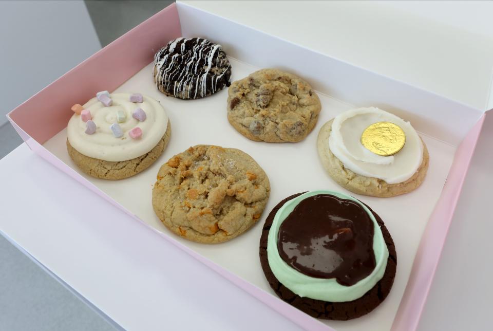 A sampling of cookies including clockwise from top left: Cookies & Cream, Milk Chocolate Chip, Sugar (Gold Coin), Mint Brownie, Butterscotch Chip and Mallow Creme at  Crumbl Cookies on North Central Avenue in Hartsdale, photographed March 15, 2023. 