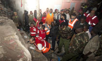 <p>Kenya Red Cross personnel search the site of a building collapse in Nairobi, Kenya, April 30, 2016. <i>(Photo: Sayyid Abdul Azim/AP)</i></p>