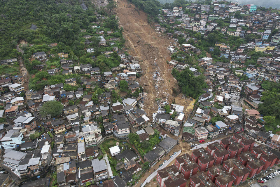 An aerial view shows a neighborhood affected by landslides in Petropolis, Brazil, Wednesday, Feb. 16, 2022. Heavy rains set off mudslides and floods in a mountainous region of Rio de Janeiro state, killing multiple people, authorities reported. (AP Photo/Silvia Izquierdo)