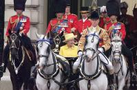 <p>Queen Elizabeth rides in on a horse-drawn carriage.</p>