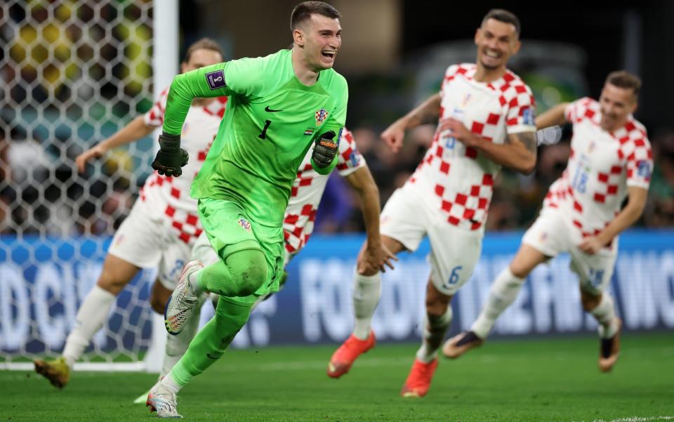 Dominik Livakovic of Croatia celebrates the win via a penalty shootout during the FIFA World Cup Qatar 2022 quarter final match between Croatia and Brazil at Education City Stadium - Alex Grimm/Getty Images