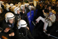 Protesters scuffle with anti riot policemen at the end of the gathering to mark the International Women's Day in Istanbul, Turkey, Wednesday, March 8, 2023. Women in Turkey and their allies converged on a central Istanbul neighborhood to demonstrate for women's rights and protest the human-made toll of the deadly quake that hit Turkey a month ago. (AP Photo/Khalil Hamra)