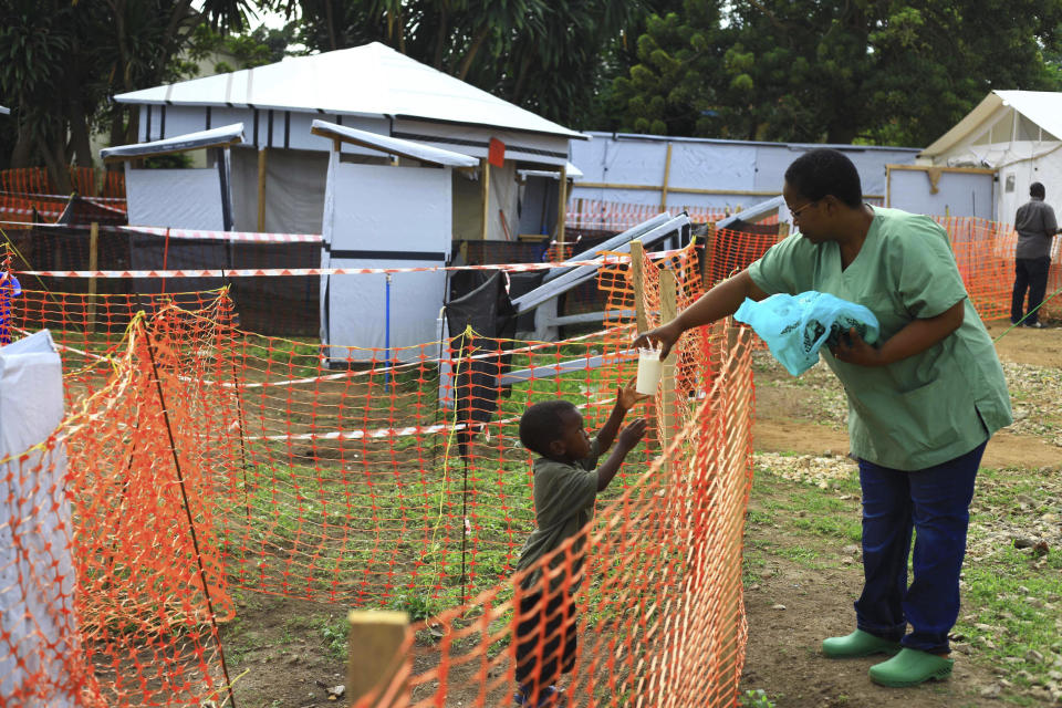 FILE - In this Sunday, Sept. 9, 2018 file photo, a health worker feeds a boy suspected of having the Ebola virus at an Ebola treatment centre in Beni, Eastern Congo. The World Health Organization says Ebola deaths in Congo's latest outbreak are expected to exceed 1,000 later on Friday, May 3, 2019. WHO's emergencies chief made the announcement at a news conference in Geneva. The Ebola outbreak that was declared in eastern Congo in August is already the second deadliest outbreak in history, and efforts to control it have been complicated by a volatile security situation and deep community mistrust. (AP Photo/Al-hadji Kudra Maliro, File)