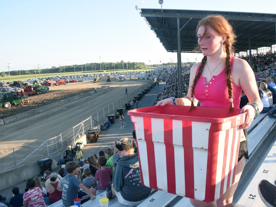 Briella Pearce sold popcorn during the Combine Demolition Derby at the 2023 Monroe County Fair. The fair set an attendance record in 2023.