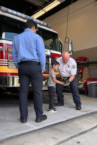 <p>Orange County Fire Rescue Department, Florida/Facebook</p> James Garcia uses a hose at Orange County Fire Rescue's station 58