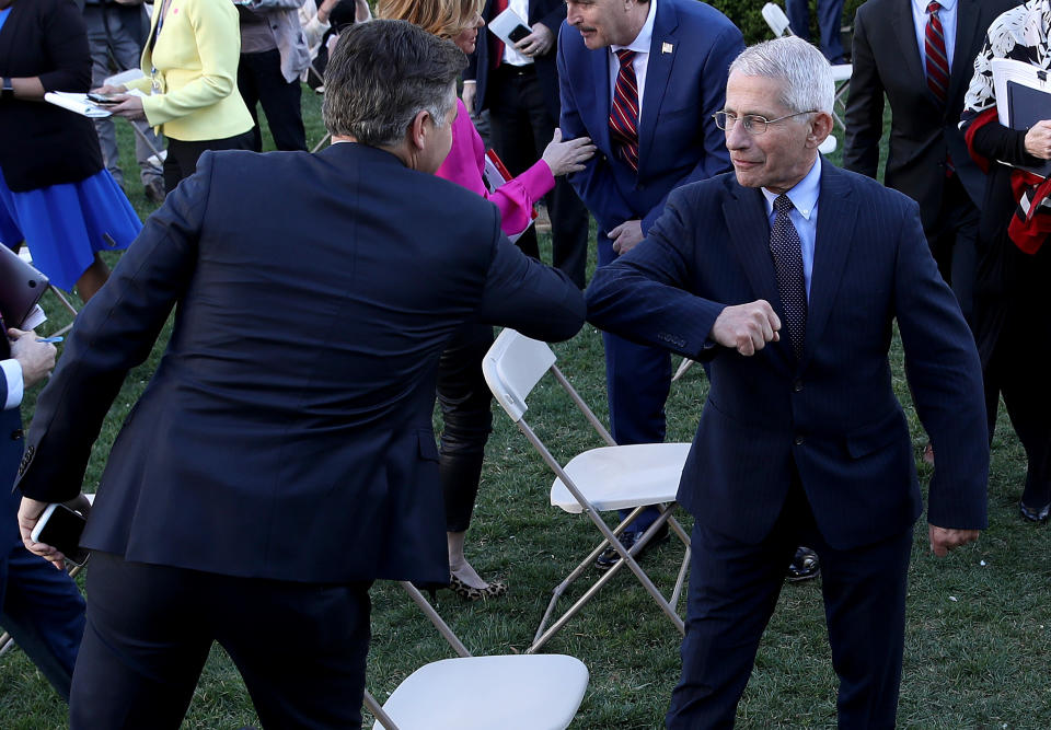 In Washington, D.C., Dr. Anthony Fauci (R), National Institute of Allergy and Infectious Diseases Director, bumps elbows with CNN correspondent Jim Acosta after the daily coronavirus briefing at the White House. (Photo by Win McNamee/Getty Images)