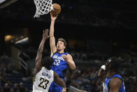 Orlando Magic forward Franz Wagner (22) goes up to shoots as Indiana Pacers forward Aaron Nesmith (23) defends during the first half of an NBA basketball game, Sunday, March 10, 2024, in Orlando, Fla. (AP Photo/Phelan M. Ebenhack)